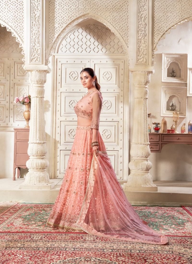 Designer embroidered flared net lehenga in dark peach