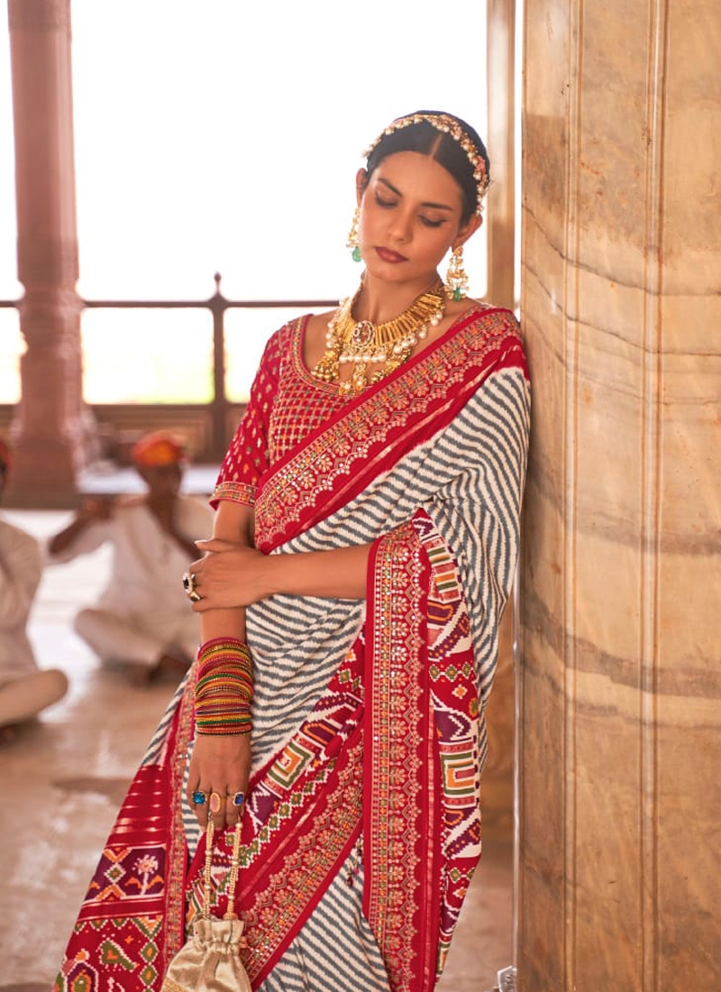 Traditional patola print saree with heavy embroidery in Pink