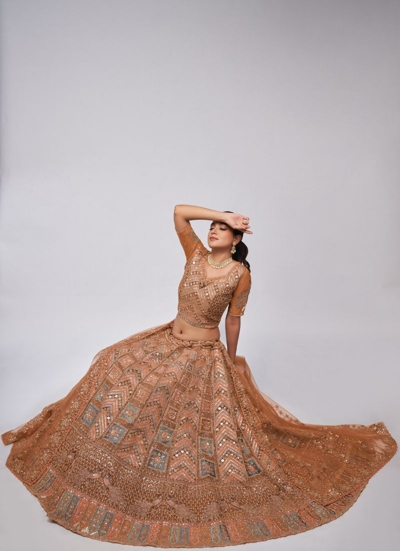 Beautiful patterns  zari embroidery in peacock and paisley motifs perfect bridal  lehenga in brown