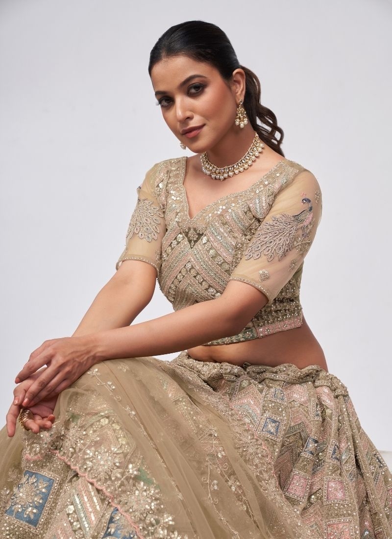 Beautiful patterns  zari embroidery in peacock and paisley motifs perfect bridal  lehenga in beige