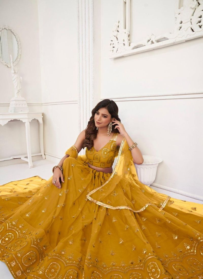 Stunning embroidered net lehenga choli in yellow