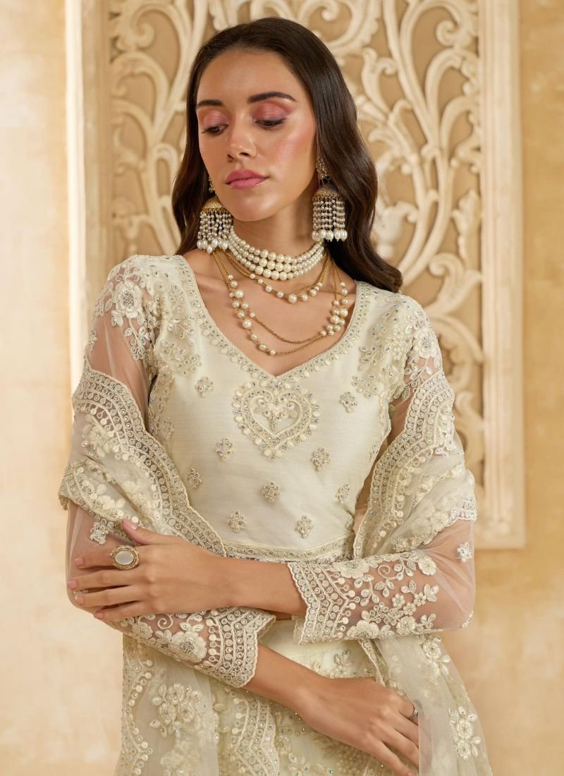 Trendy thread embroidered net lehenga in cream