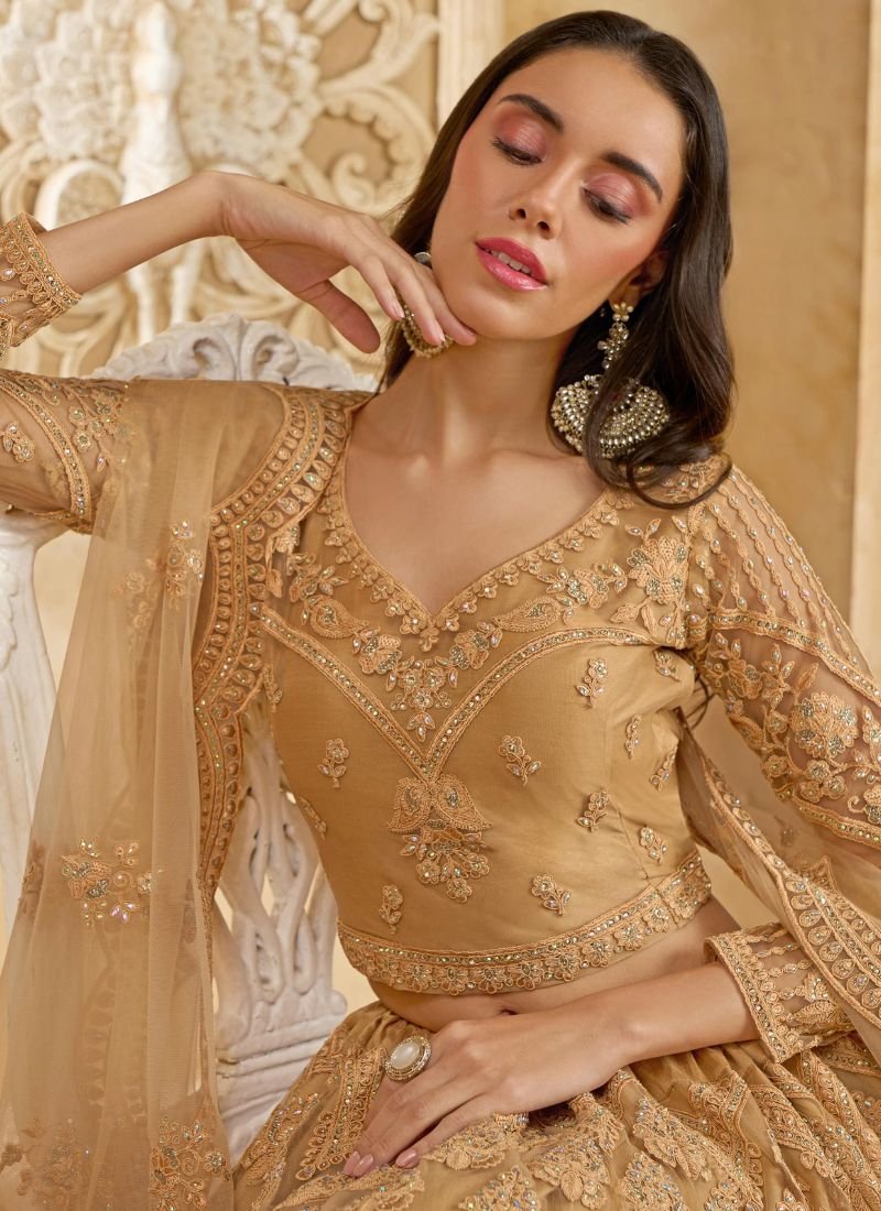 Trendy stone embroidered net lehenga in golden