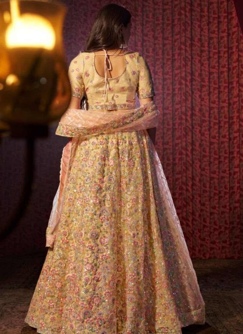 Stylish thread embroidered net lehenga choli in yellow