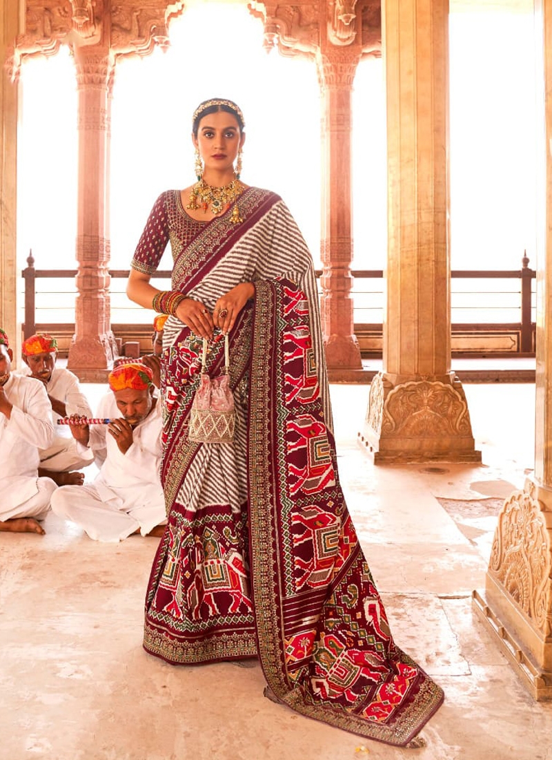 Traditional patola print saree with heavy embroidery in Maroon