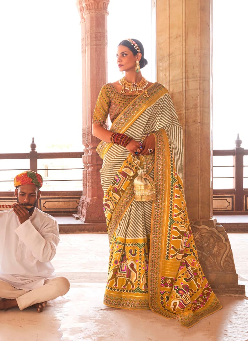 Traditional patola print saree with heavy embroidery in Light Yellow