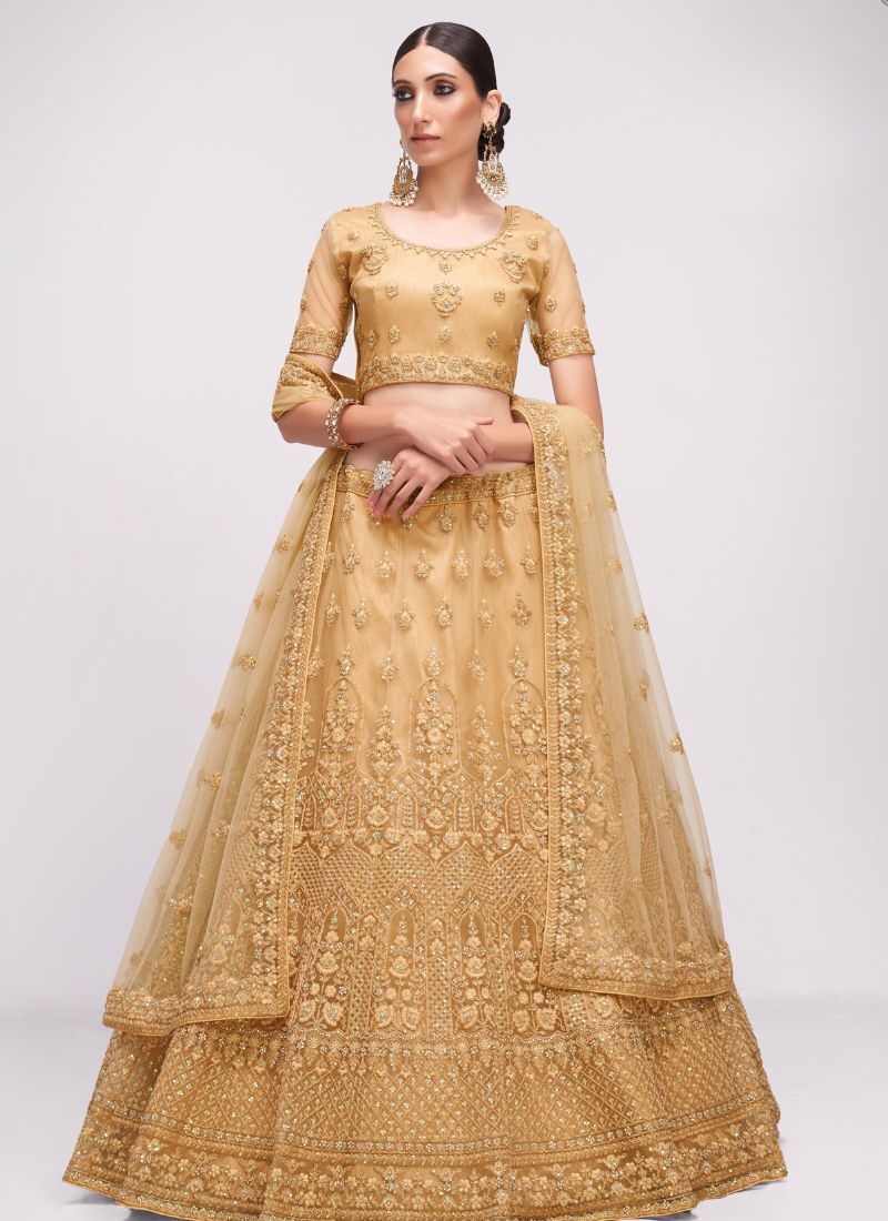 Designer stonework embroidered net lehenga choli in golden