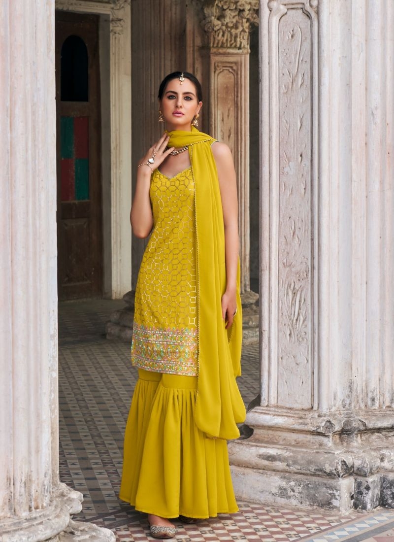 Exquisite heavy flare embroidered sharara suit in yellow