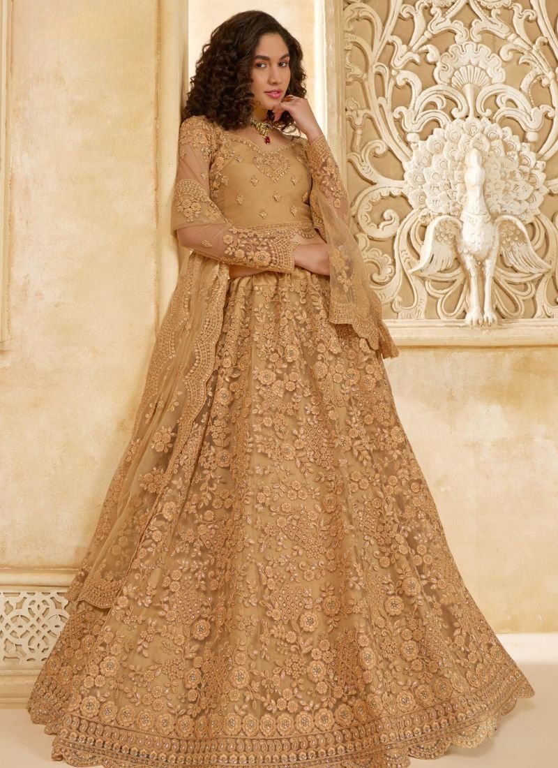 Trendy thread embroidered net lehenga in golden