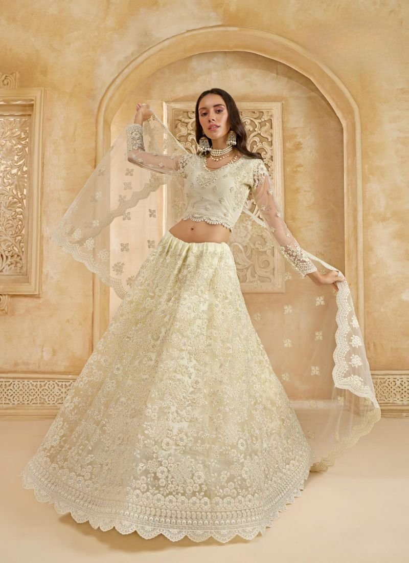 Trendy thread embroidered net lehenga in cream