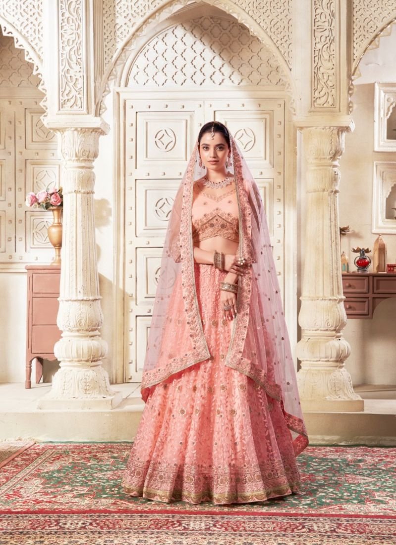 Designer embroidered flared net lehenga in dark peach