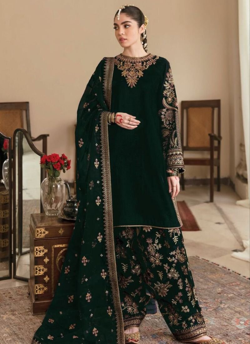 Exquisite heavy embroidered velvet salwar suit in dark green