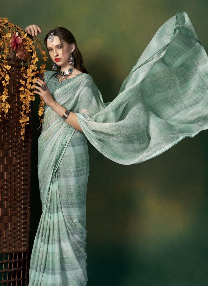 Elegant pattern worked georgette saree in light green